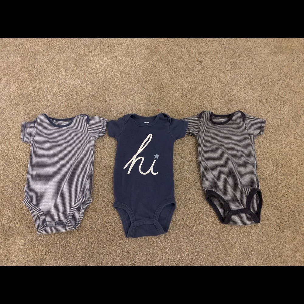 Three Carter’s onesies.
